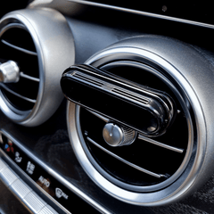 Smul luxury car air freshener attached to the car's air inlet. The interior is of a Mercedes C-class 300.